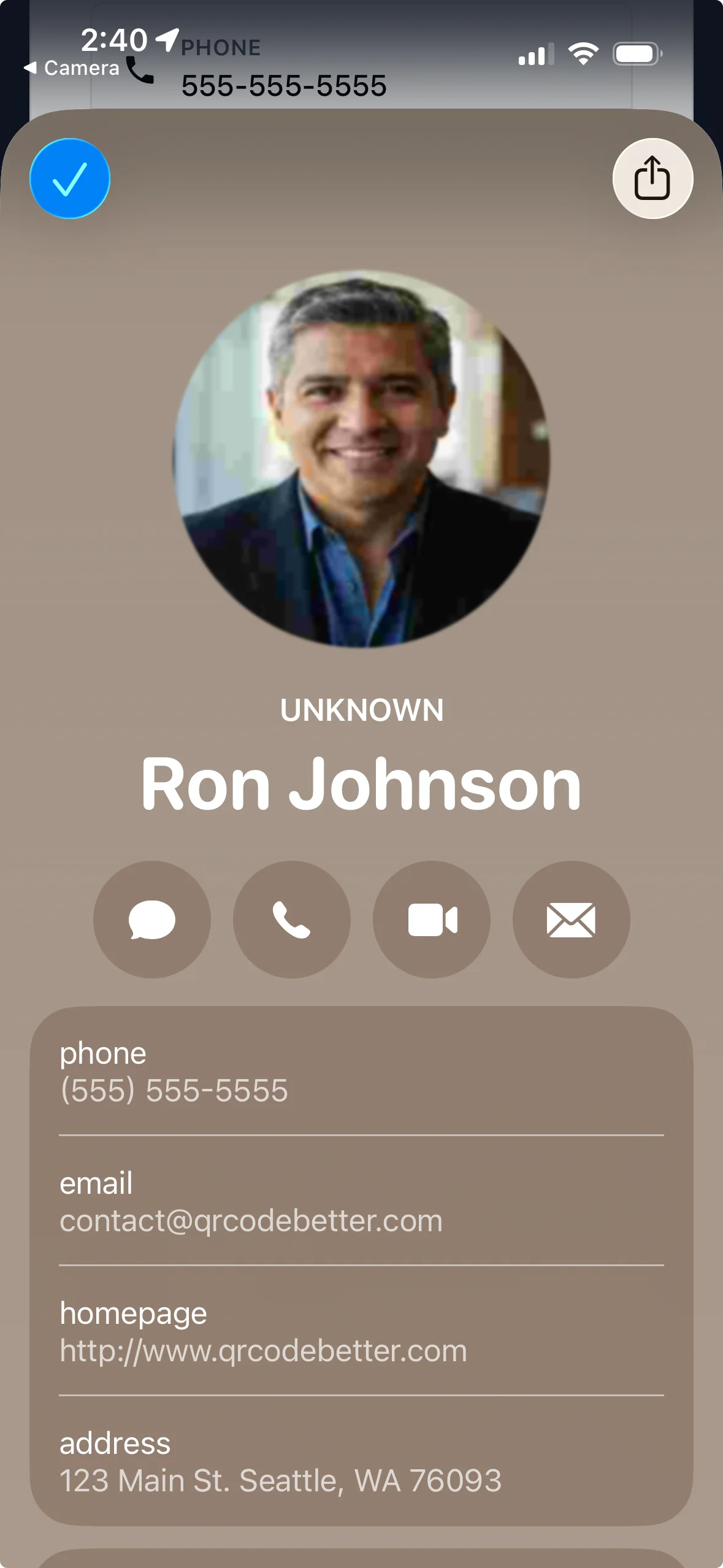 iPhone showing saved contact after scanning a QR code business card with name, phone, email and address